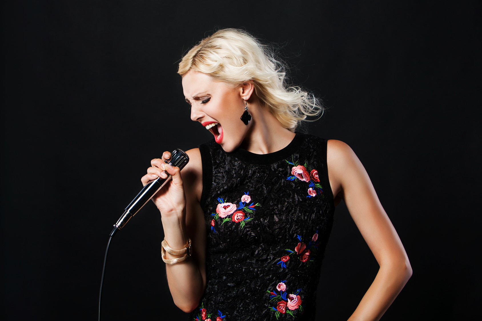 portrait of pop female singer with microphone